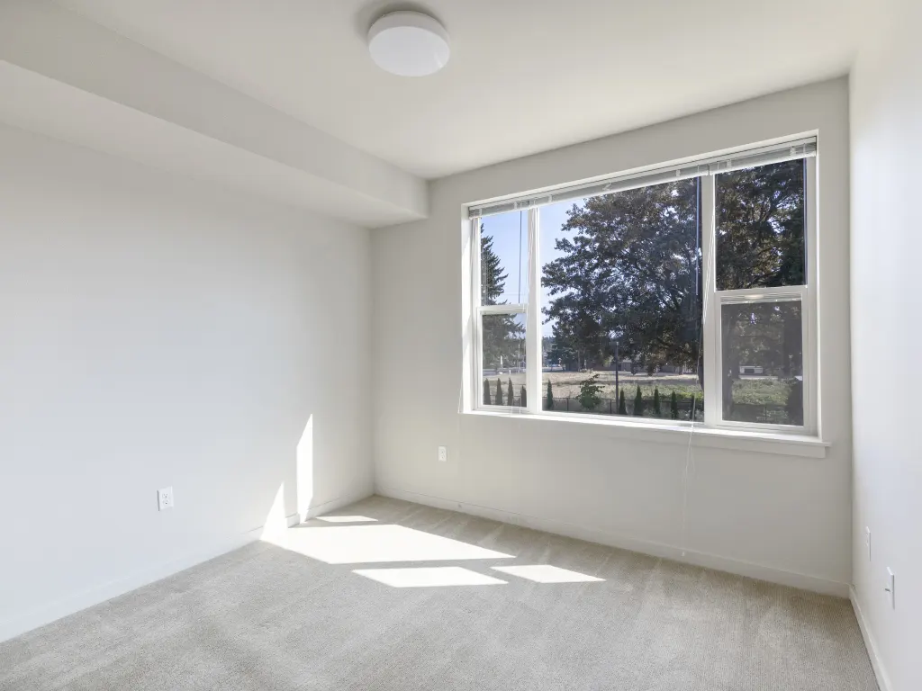 Bright room with clear window view, enhanced for real estate listings.